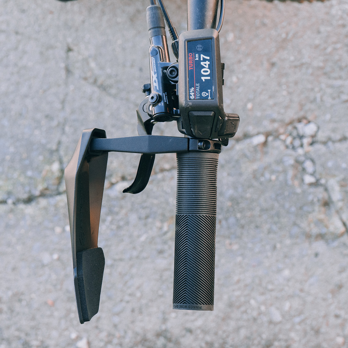 Guard mounted to an e-bike, showing an example configuration with an e-bike handlebar mounted controller.